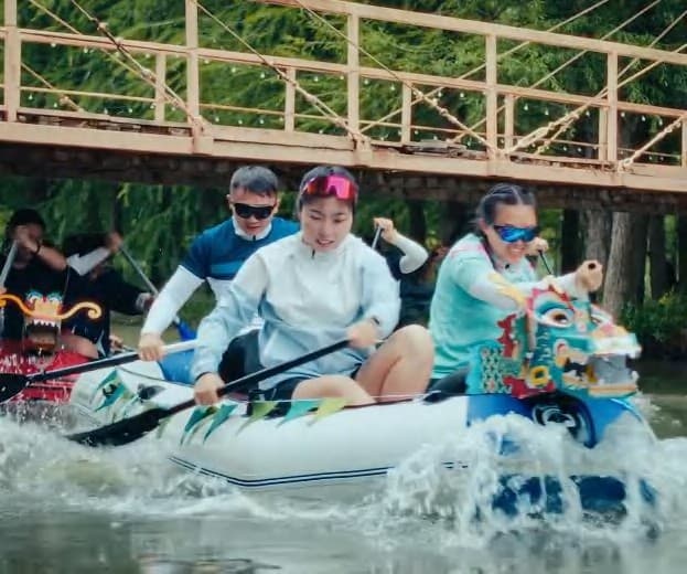 A group paddling an inflatable boat on a river